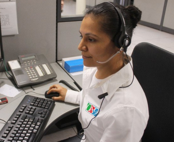 Woman working on a computer with a headset on